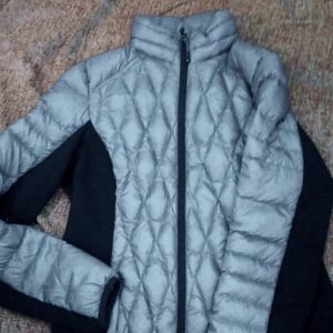 A coat that's water resistant, a grey and black color.